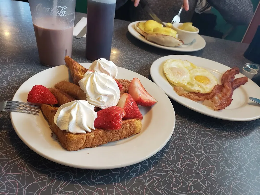 French Toast with over Easy Eggs and Bacon Strips